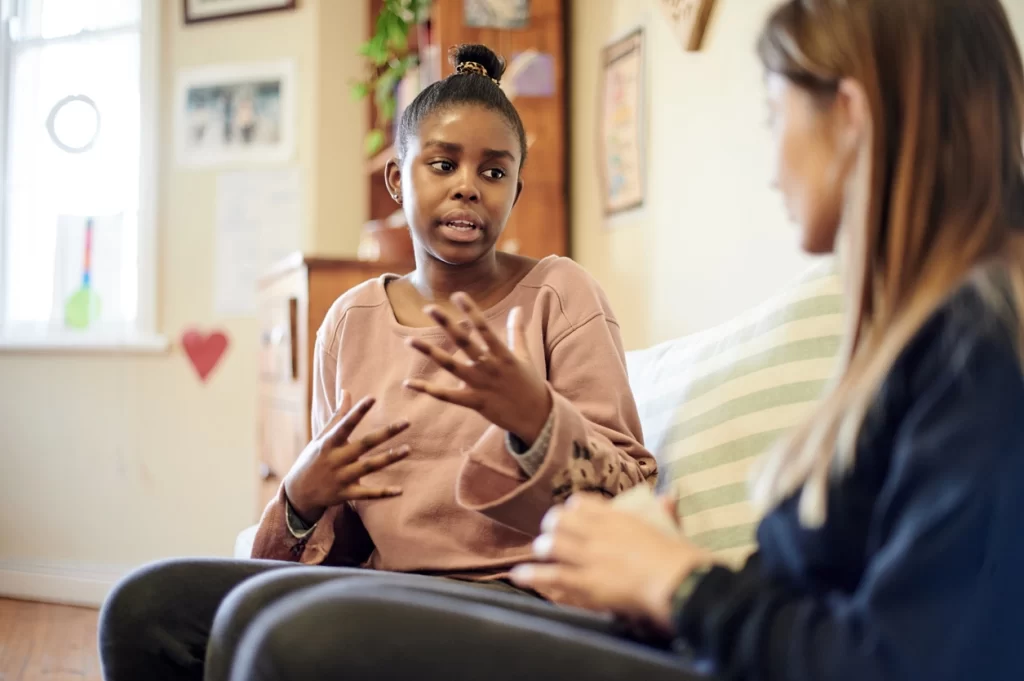 Professional contact worker providing compassionate support to a parent during a family contact session at Truevale Care's Child Contact Centre